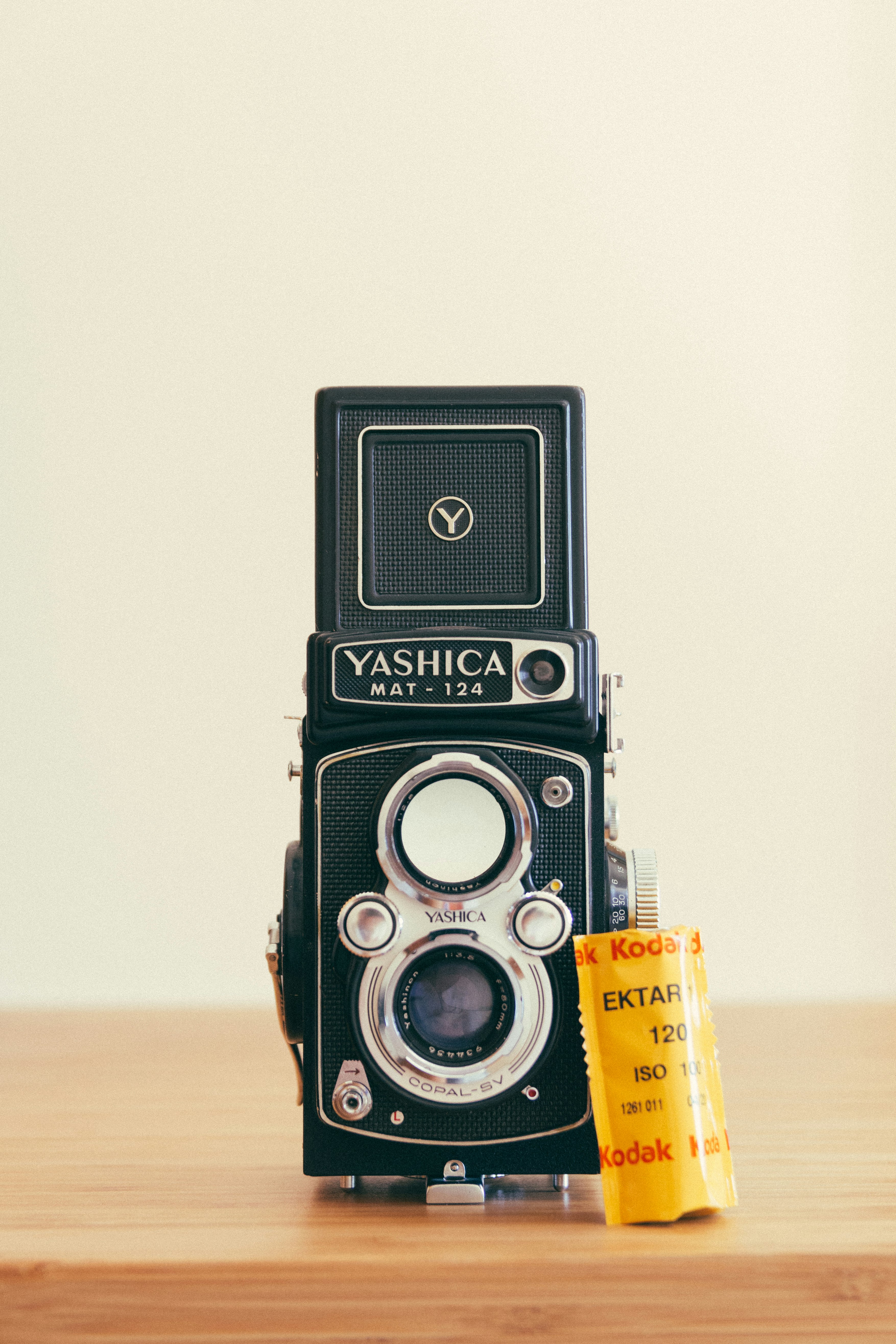 gray and black Yashica camera on brown surface